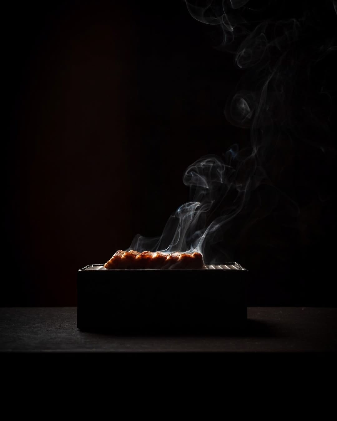 Sushi rolls presented against a dark setting