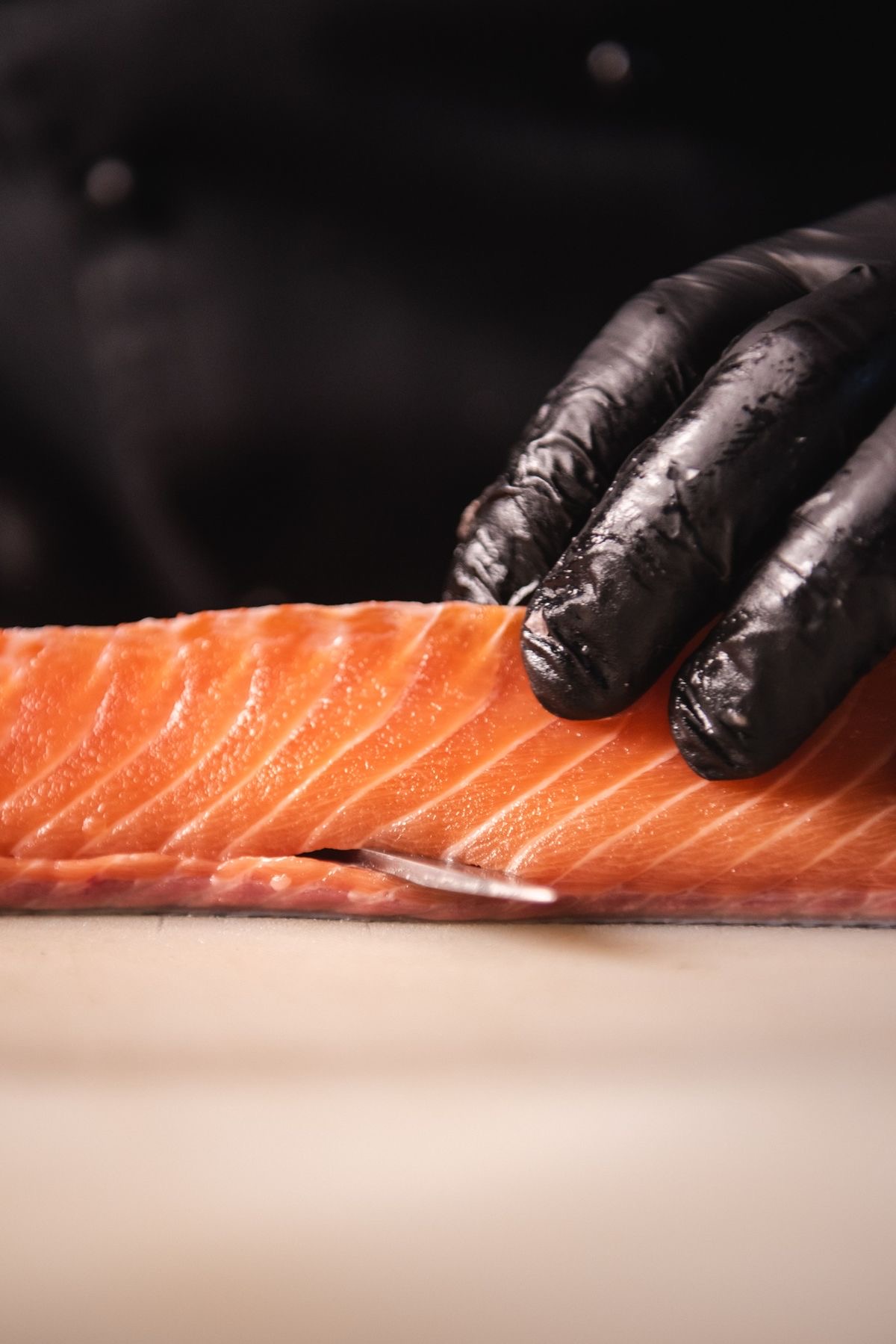 Close-up of a chef carefully preparing salmon